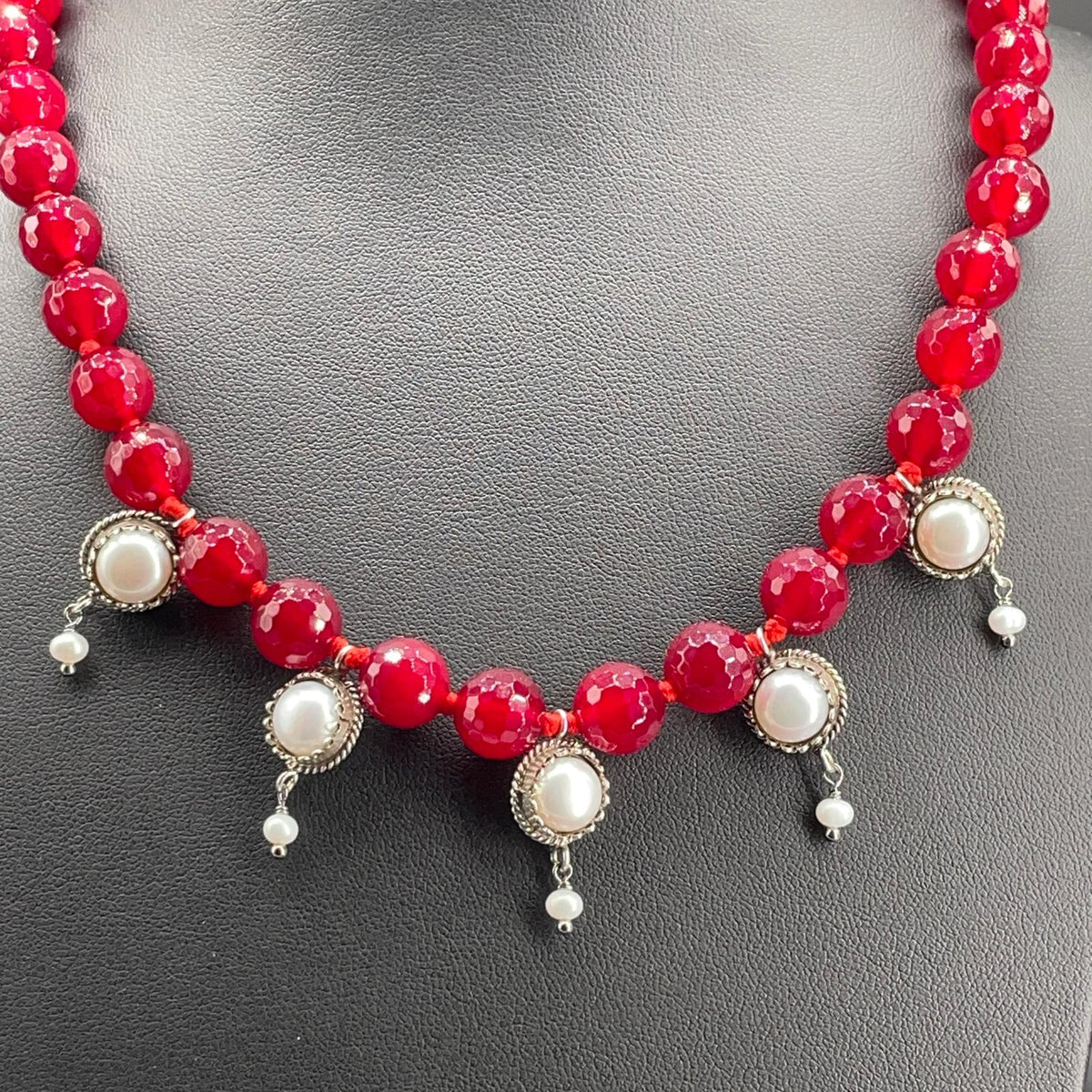Dettaglio delle sfere di agata rossa e dei cinque pendenti con perle coltivate in argento 925